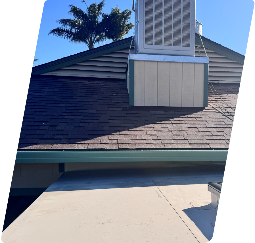A close-up view of an Alo's Roofing structural repair showcasing clean brown asphalt shingles meeting a smooth tan flat low-slope roof membrane beneath a commercial HVAC unit.