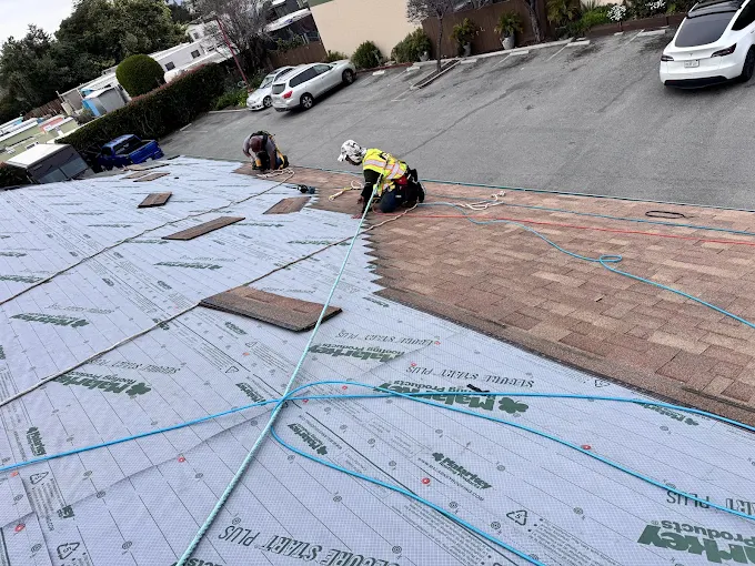 Alo's Roofing crew installing Malarkey underlayment during a residential roof replacement in Santa Cruz County, CA
